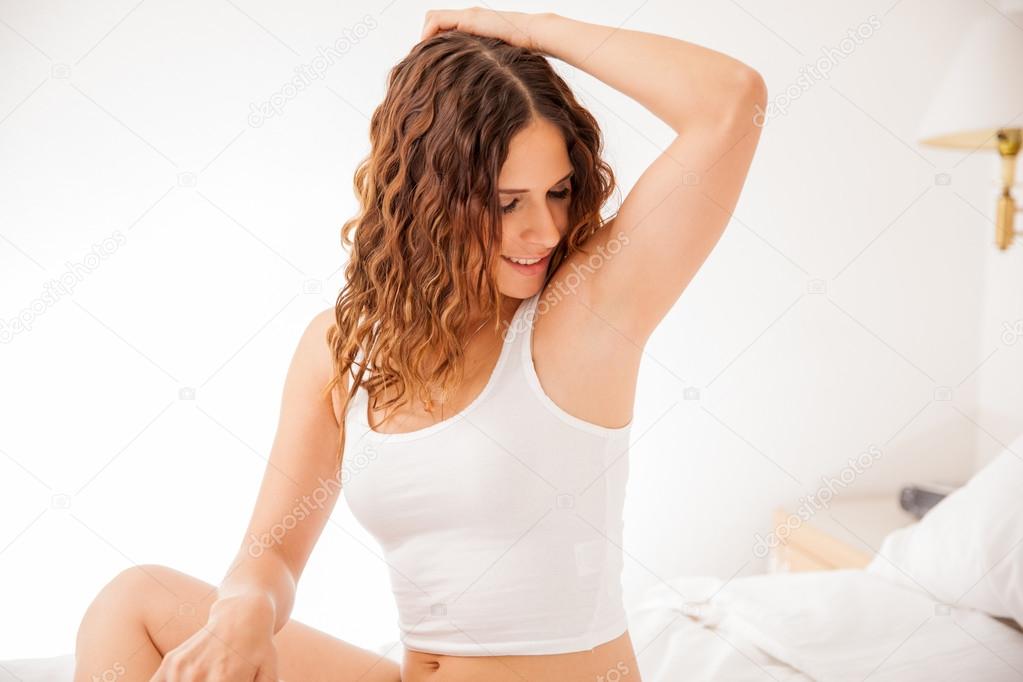 Young woman showing her smooth armpits