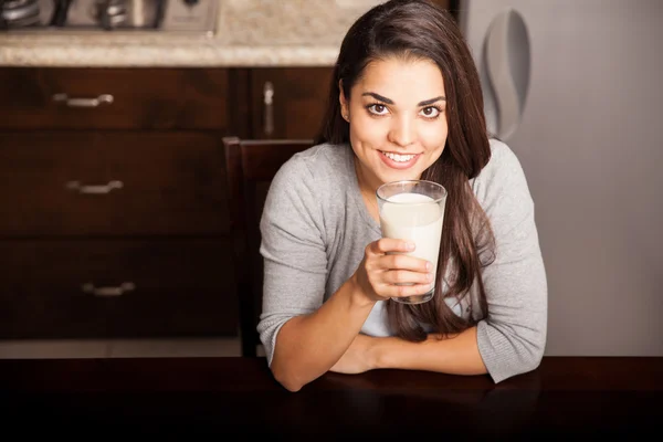 Hispanic woman with a glass of milk