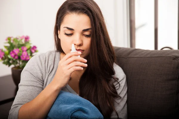 Sick woman with nose spray — Stock Photo, Image