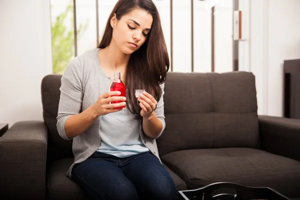 Woman with cough syrup — Stock Photo, Image