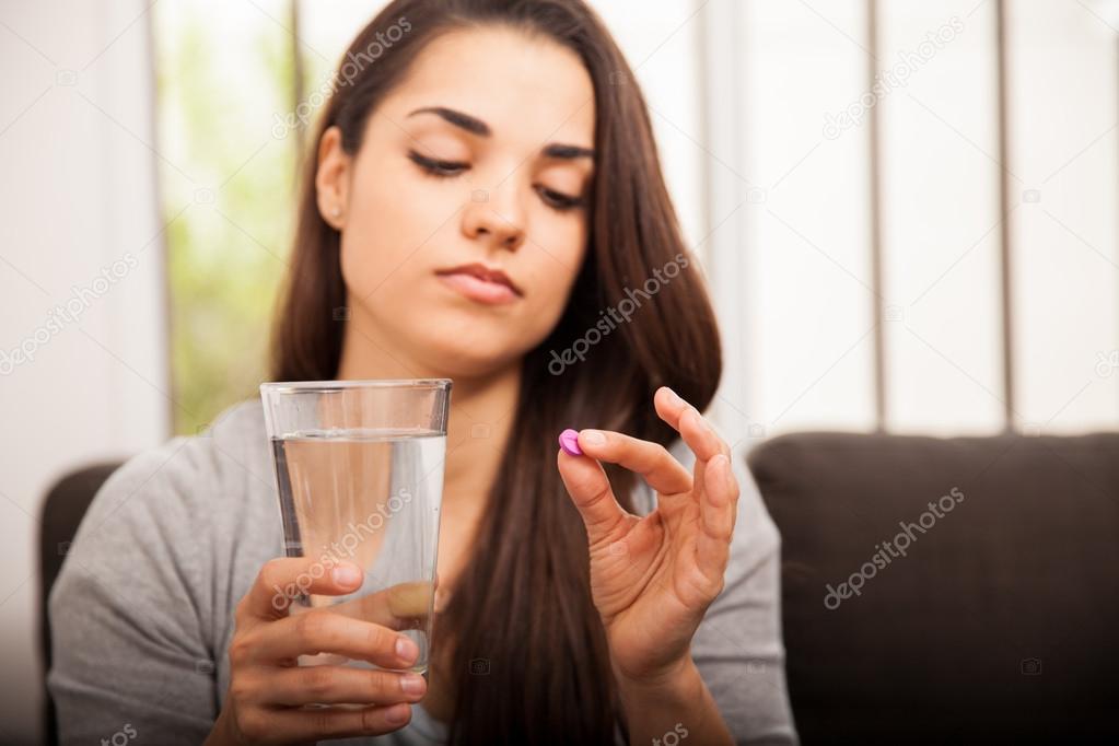 Woman about to take a pill