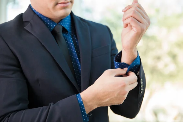 Businessman buttoning sleeve — Stock Photo, Image