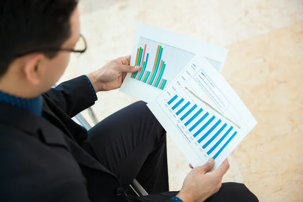 Businessman looking performance charts — Stock Photo, Image