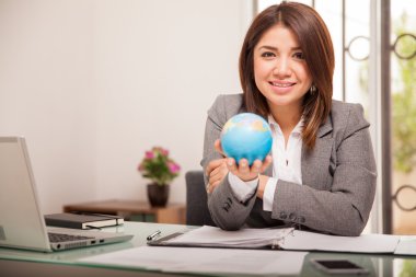 Business woman holding  globe clipart