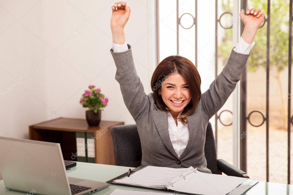 Business woman raising her arms
