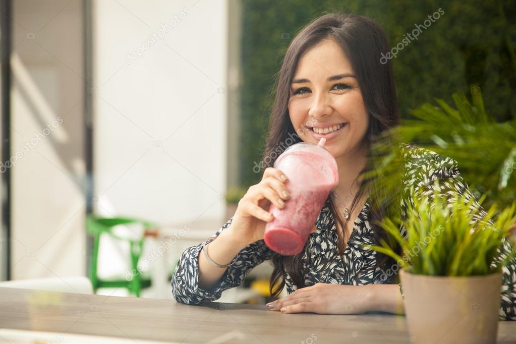 Woman taking a smoothie break