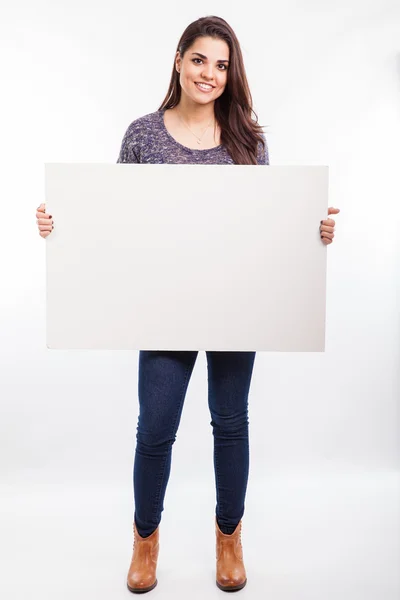 Woman holding a big white sign — Stock Photo, Image