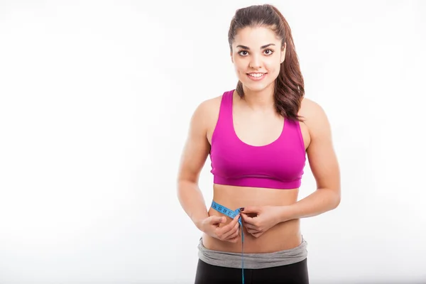 Woman measuring her waistline — Stock Photo, Image