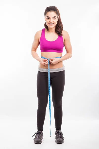 Woman measuring her waistline — Stock Photo, Image