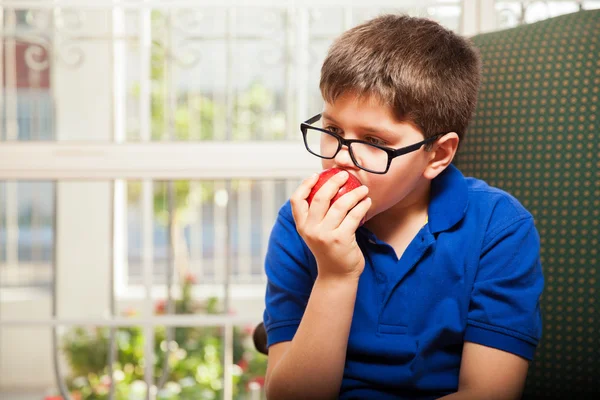 Boy biting and apple — Stock Photo, Image