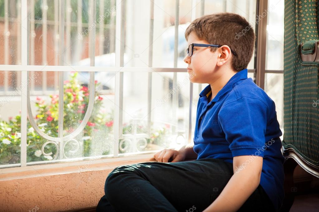 Boy sitting in front of a window