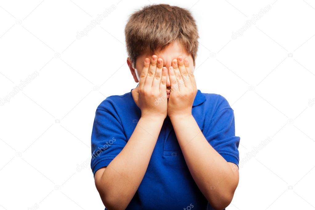 Boy covering his face