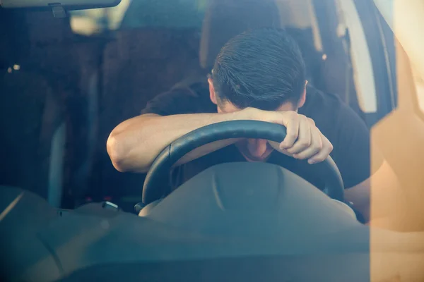 Man leaning on the steering wheel. — Stock Photo, Image