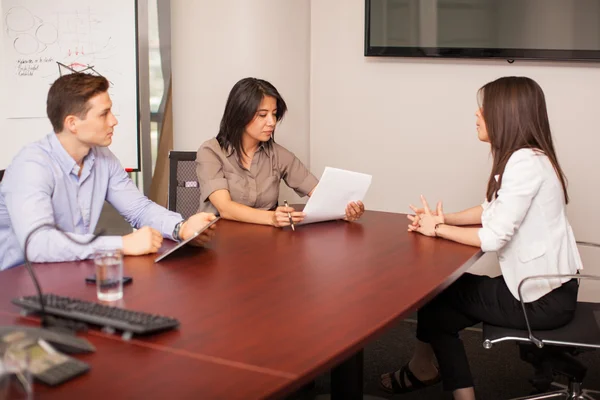 Woman sitting in front of a couple — Stockfoto