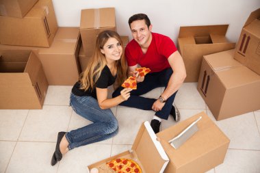 Happy couple  eating some pizza clipart