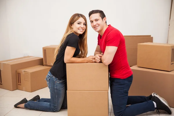 Couple leaning on a pile of boxes — Stock Photo, Image