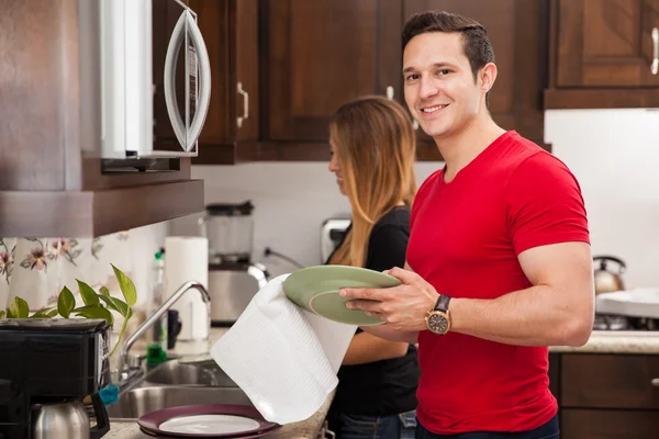 Handsome man washing the dishes — Stock Photo, Image