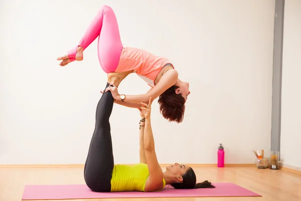 Kobiet próbuje kilka ruchów jogi akrobatycznych — Zdjęcie stockowe