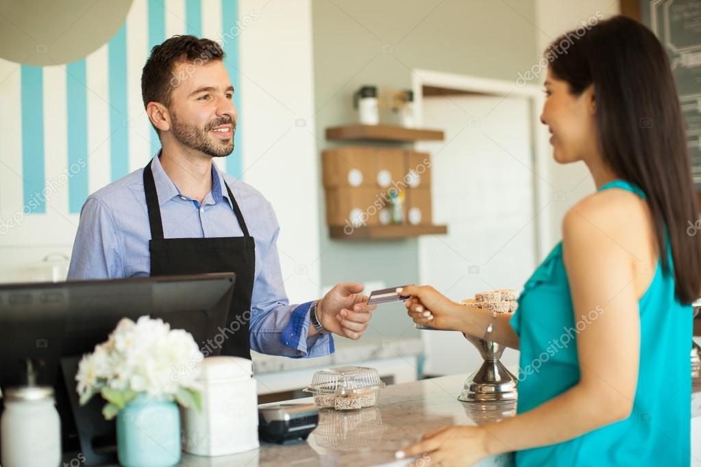 brunette paying with a credit card