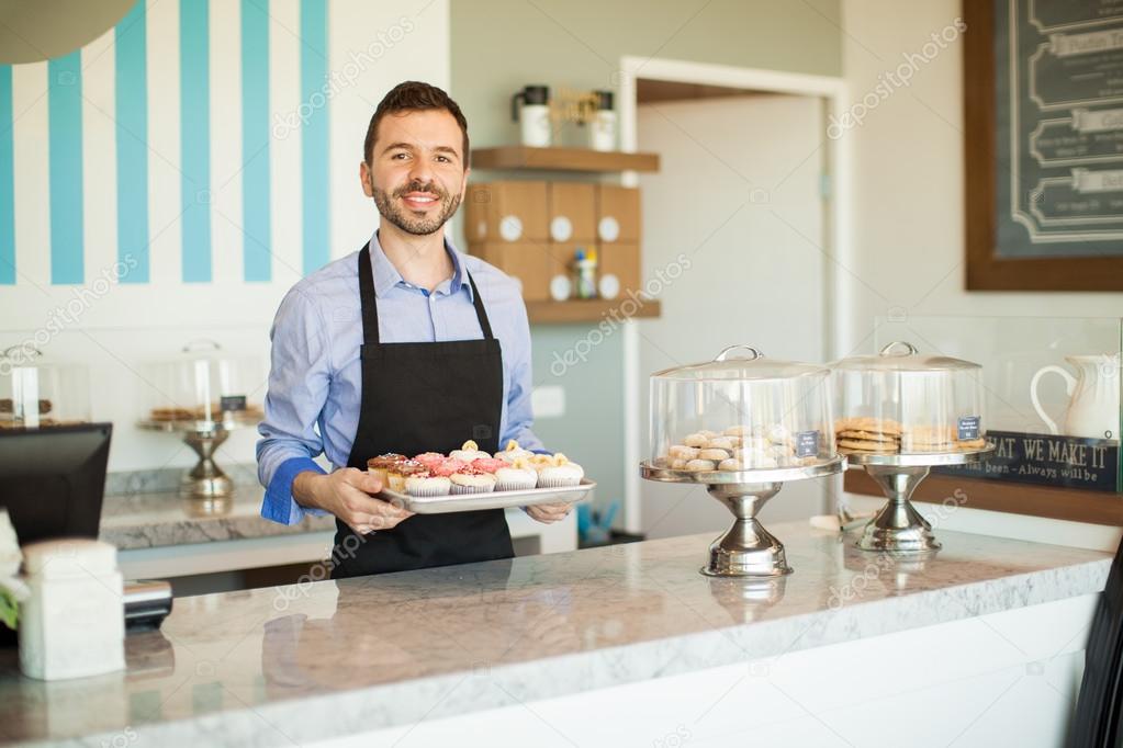 owner showing freshly baked cupcakes