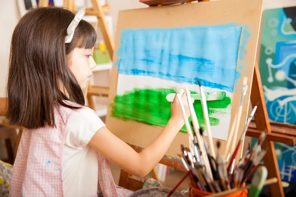 Brunette painting grass — Stock Photo, Image