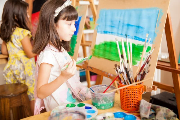 Girl taking a moment to look at  painting — Stock Photo, Image