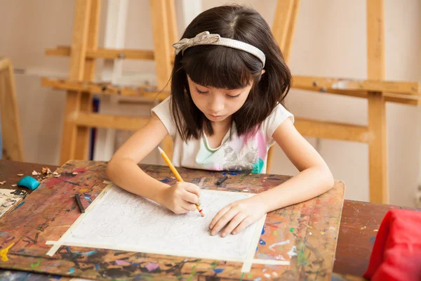 Brunette drawing with a pencil — Stock Photo, Image