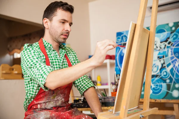 Artist wearing an apron and working — Stock Photo, Image