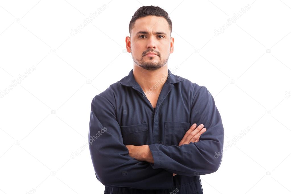 mechanic in overalls with his arms crossed