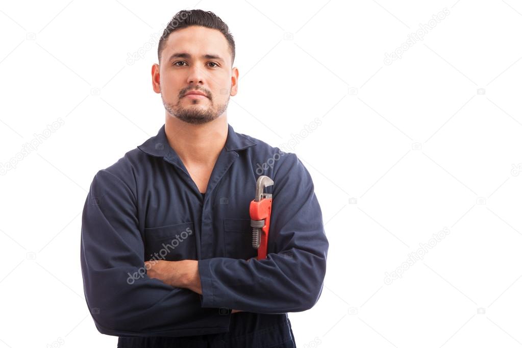 plumber in overalls holding a wrench