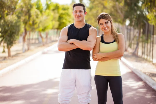 Couple standing on a running track Stock Image