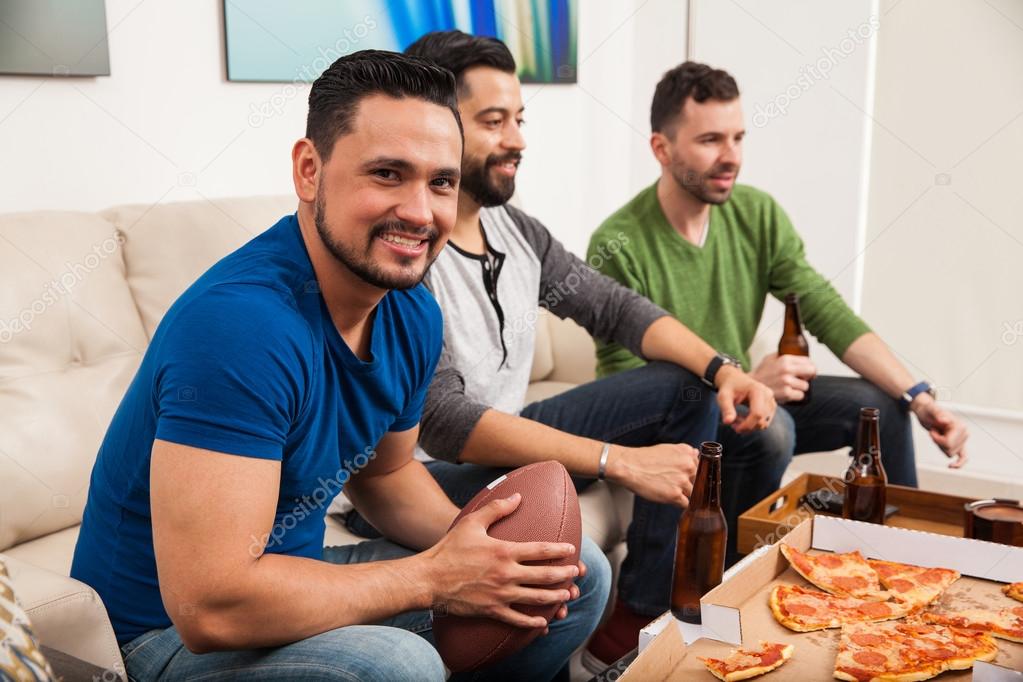 Hispanic men watching an american football
