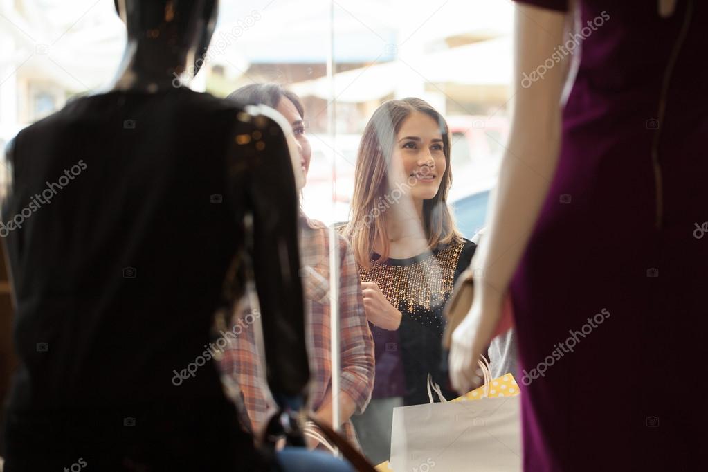 women  looking at some mannequins