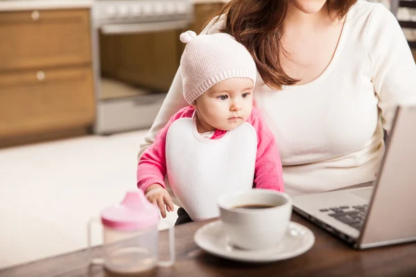 Baby flicka sitter i mammas knä — Stockfoto