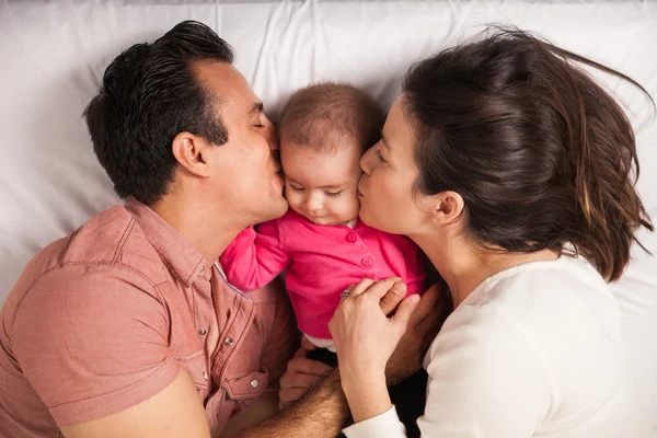 Parents kissing girl — Stock Photo, Image