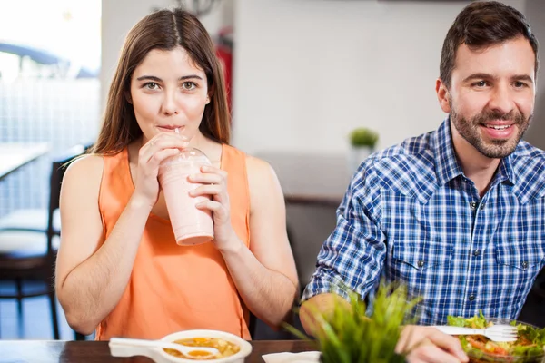 Young woman taking a sip — Stock Photo, Image