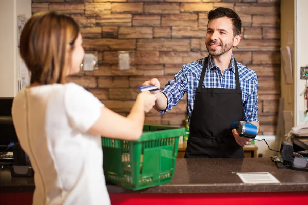 Man with a beard taking a credit card — Stock Photo, Image