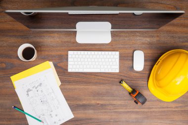 Wooden desk with a computer, a helmet