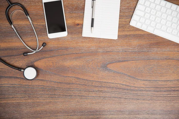Doctor's desk with a notepad, a stethoscope — Stock Photo, Image
