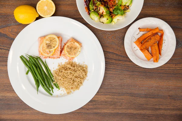 Salmon served with  lemon and beens — Stock Photo, Image