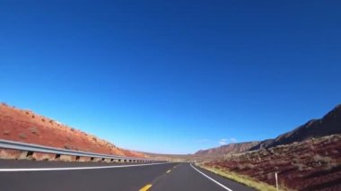 A car drives along a beautiful scenic road in California, USA.