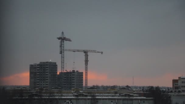 Vista de la construcción de una casa con grandes grúas de gran altura. — Vídeos de Stock