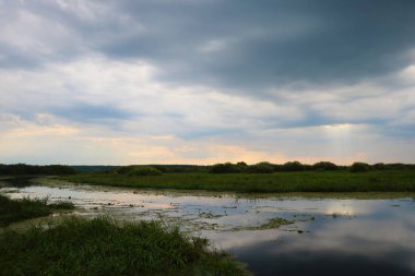 Dark sky before a thunderstorm overlooking the river