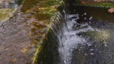 Soğuk şeffaf su taşların ve plakaların üzerinden akar..