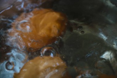 Out of focus. Blurred background. Eggs are boiled in boiling water