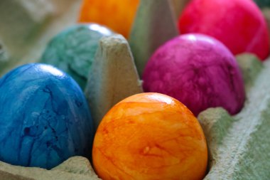 Blurred background. Out of focus. Multi-colored eggs in a package