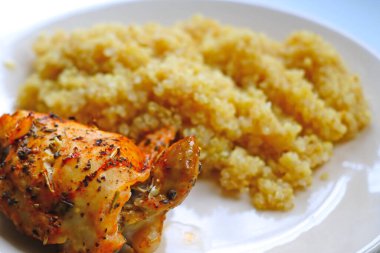 piece of fried chicken with porridge on a plate