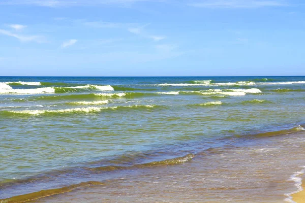 Belles vagues roulent à terre par une journée ensoleillée. — Photo