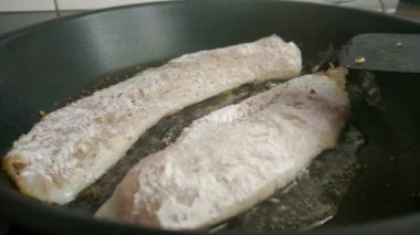 Kızartma tavasında pişmiş balık. Baharat serpilmiş.