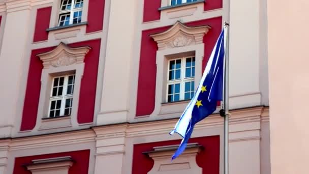 Poznan, Polen, 15 augustus 2021: Tegen de achtergrond van het gebouw wappert de vlag van de Europese Unie in de wind. — Stockvideo